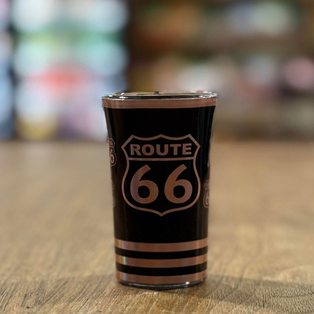 Souvenir shot glass with black finish and rose gold Route 66 graphics