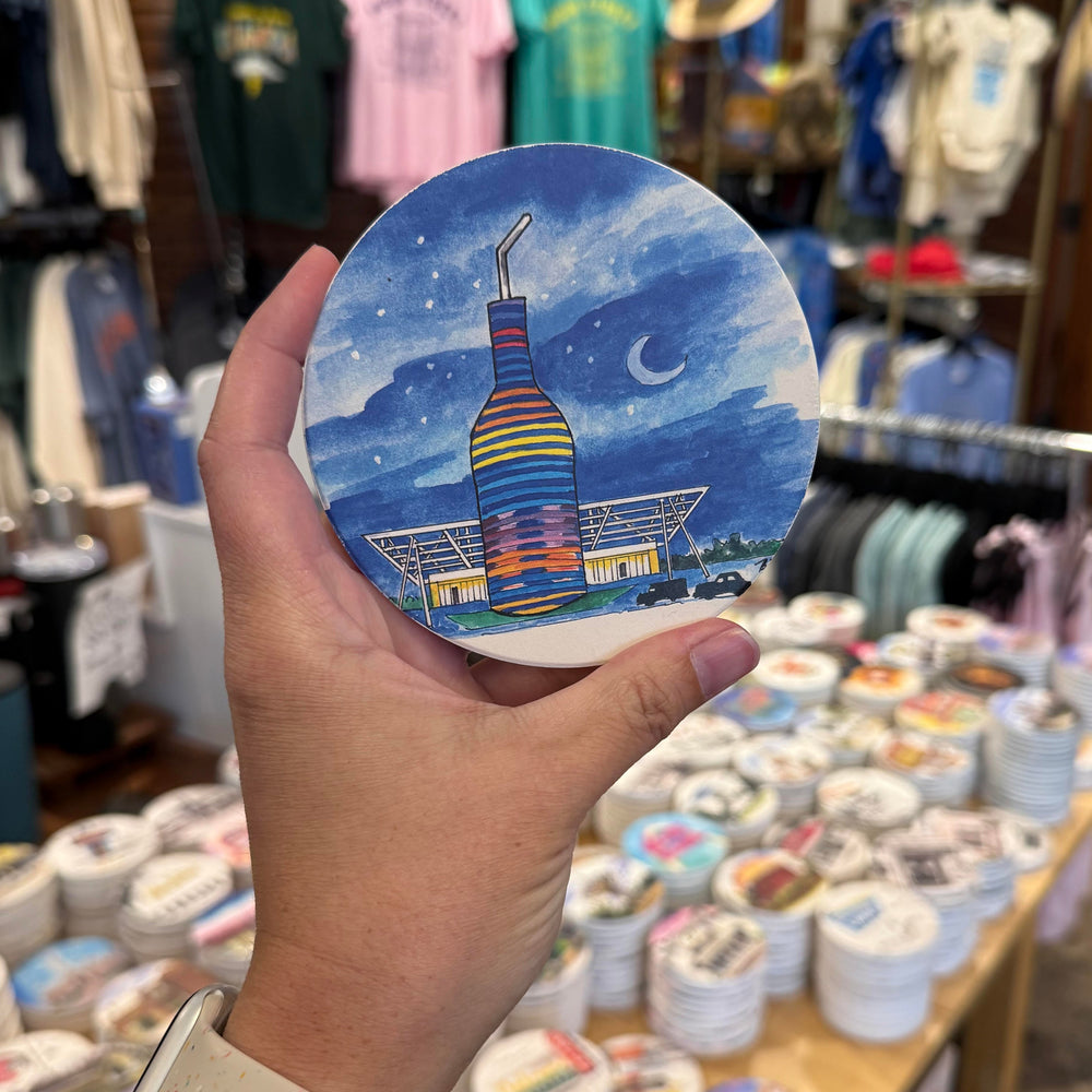 Hand-painted Pops 66 coaster with neon soda bottle and building – Arcadia Oklahoma roadside attraction
