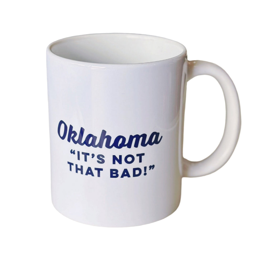 White coffee mug with black text saying "Oklahoma It's Not That Bad," perfect souvenir for Oklahoma tourists and locals