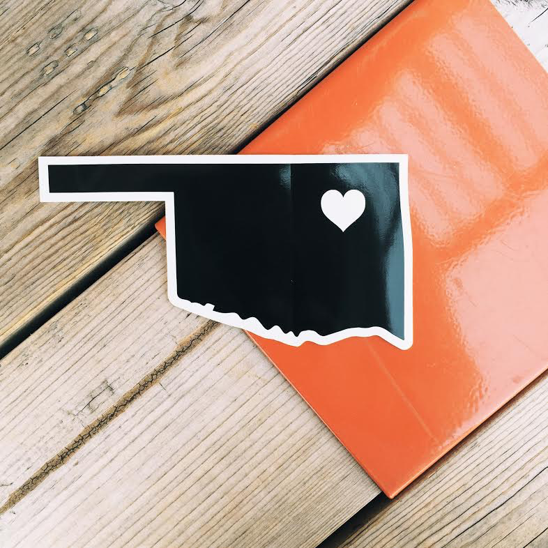 Minimalist Oklahoma decal with a heart over Tulsa in white on a black background