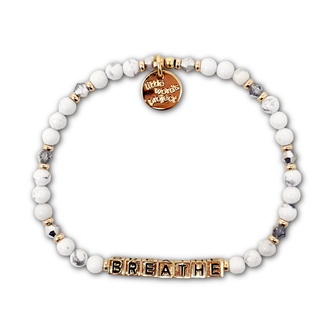 Bracelet with white and silver beads and gold letter beads spelling out "BREATHE".