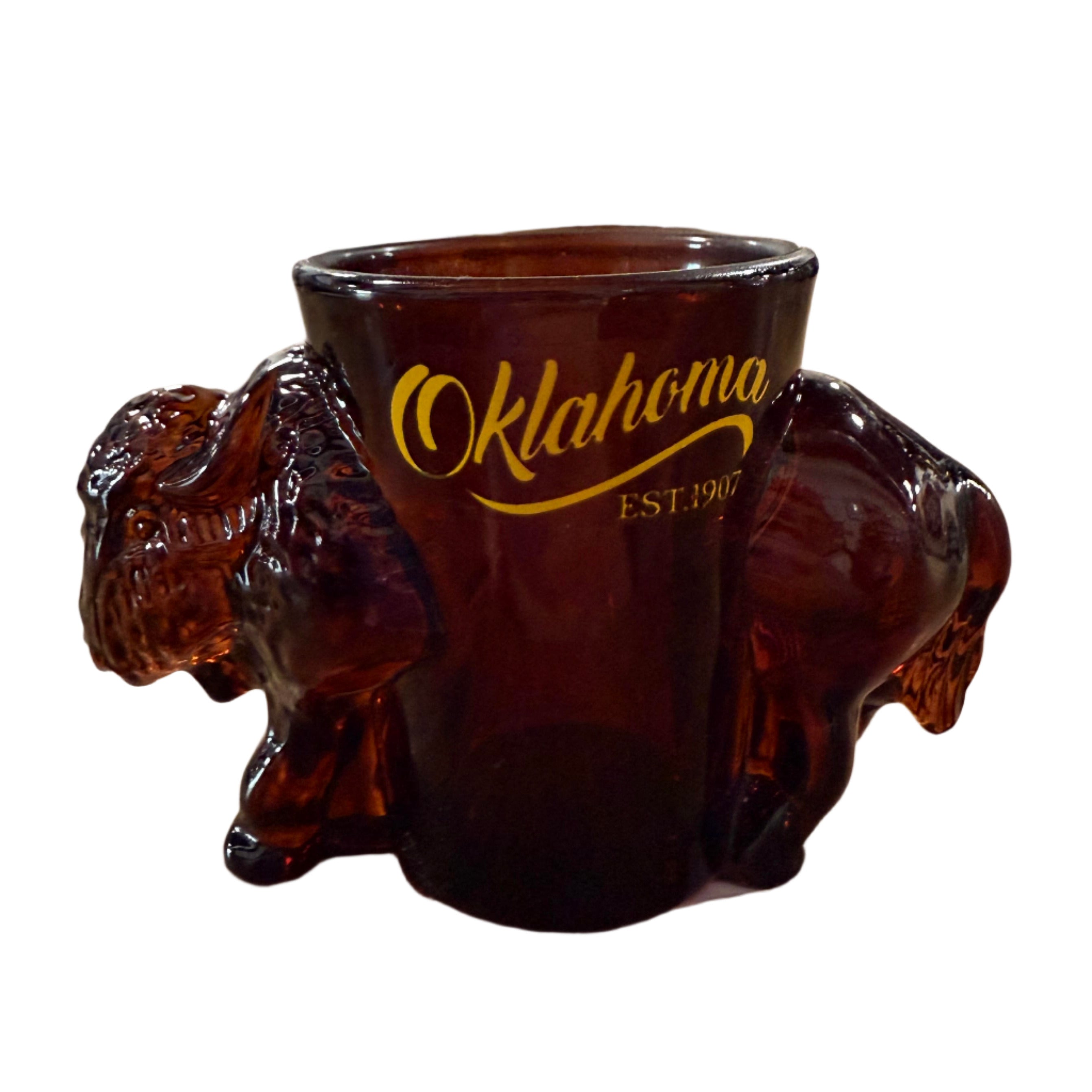 Brown Oklahoma shot glass with buffalo image and yellow lettering
