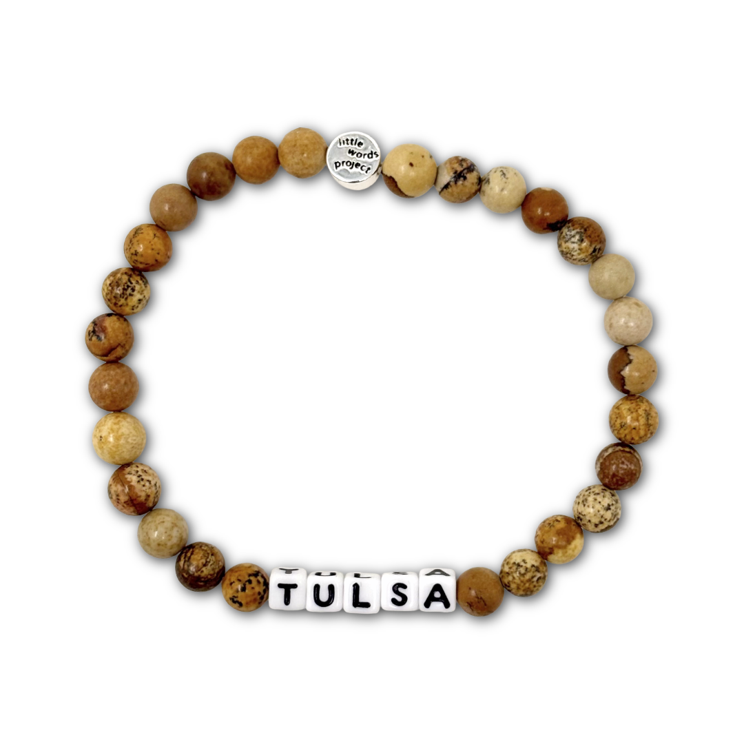 Beaded bracelet with brown cork beads and letter beads spelling out "TULSA".