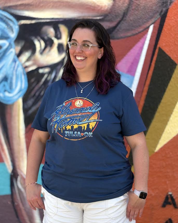 Blue Hanson “Already Home” licensed t-shirt featuring retro artwork and Tulsa skyline, music merch for fans.