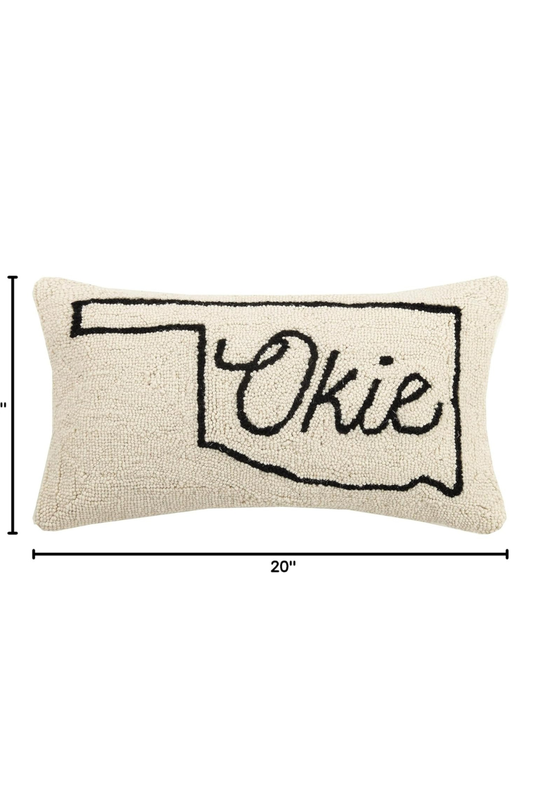 Front view of a 12x20 cream pillow with a simple Oklahoma state outline and “Okie” written in script across the center.