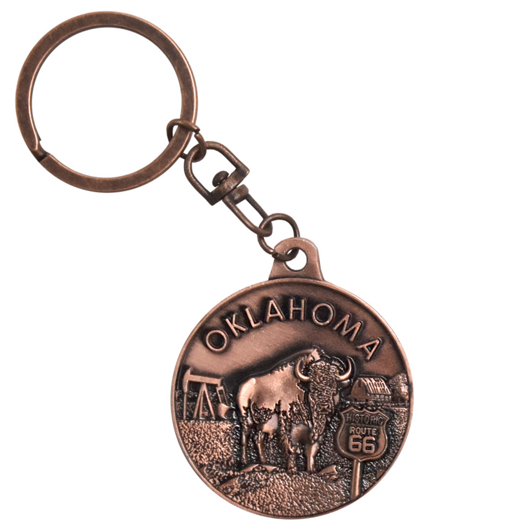 Copper keychain featuring buffalo, barn, oil rig, and Route 66 symbols with Oklahoma text