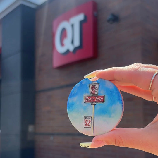 Set of two car coasters with colorful ink-style sketch of QuikTrip store