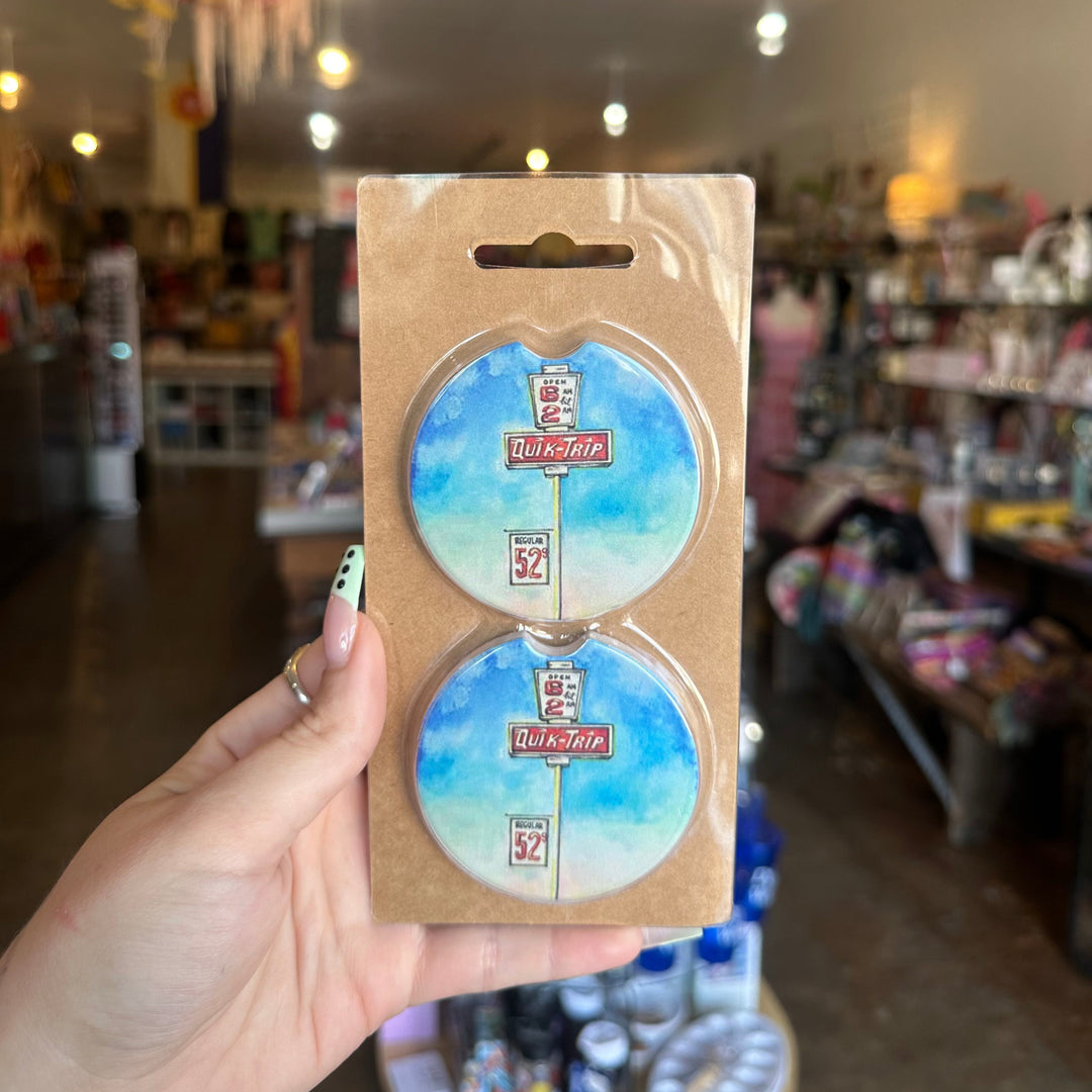 Set of two car coasters with colorful ink-style sketch of QuikTrip store