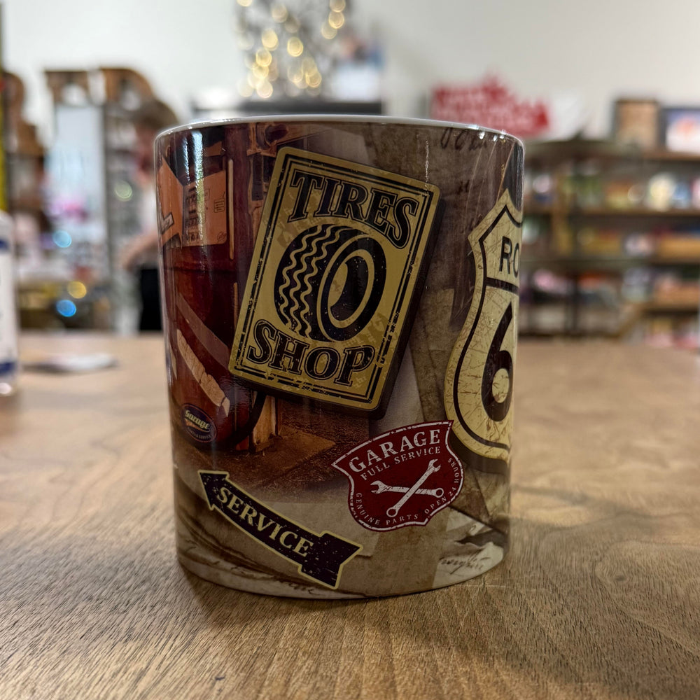 Coffee mug with Route 66 road shield and retro garage signs