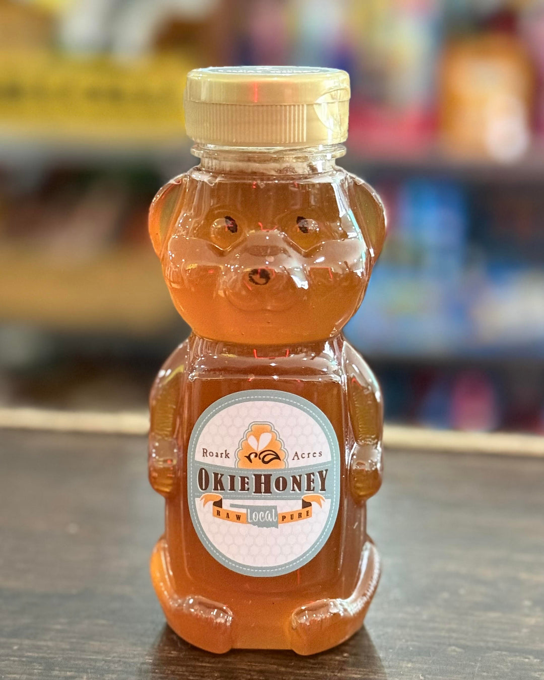12oz bear bottle of Roark Acres Okie Honey, golden raw honey from Oklahoma