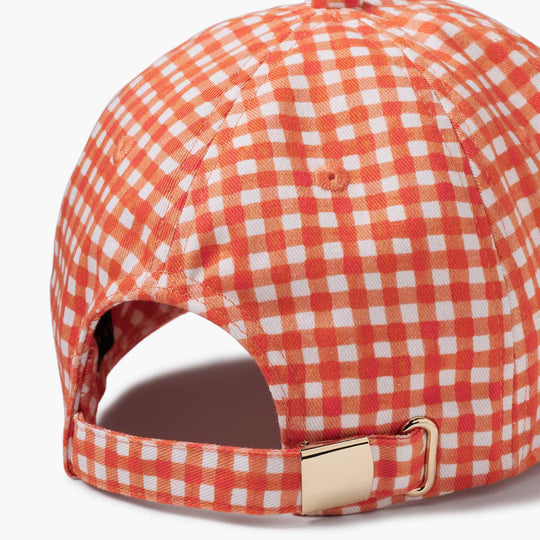 Red and white checkered cap with a gold buckle on a white background