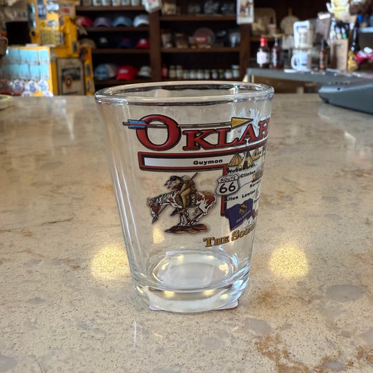 Clear glass shot glass with detailed Oklahoma map and "The Sooner State" label – great for collectors