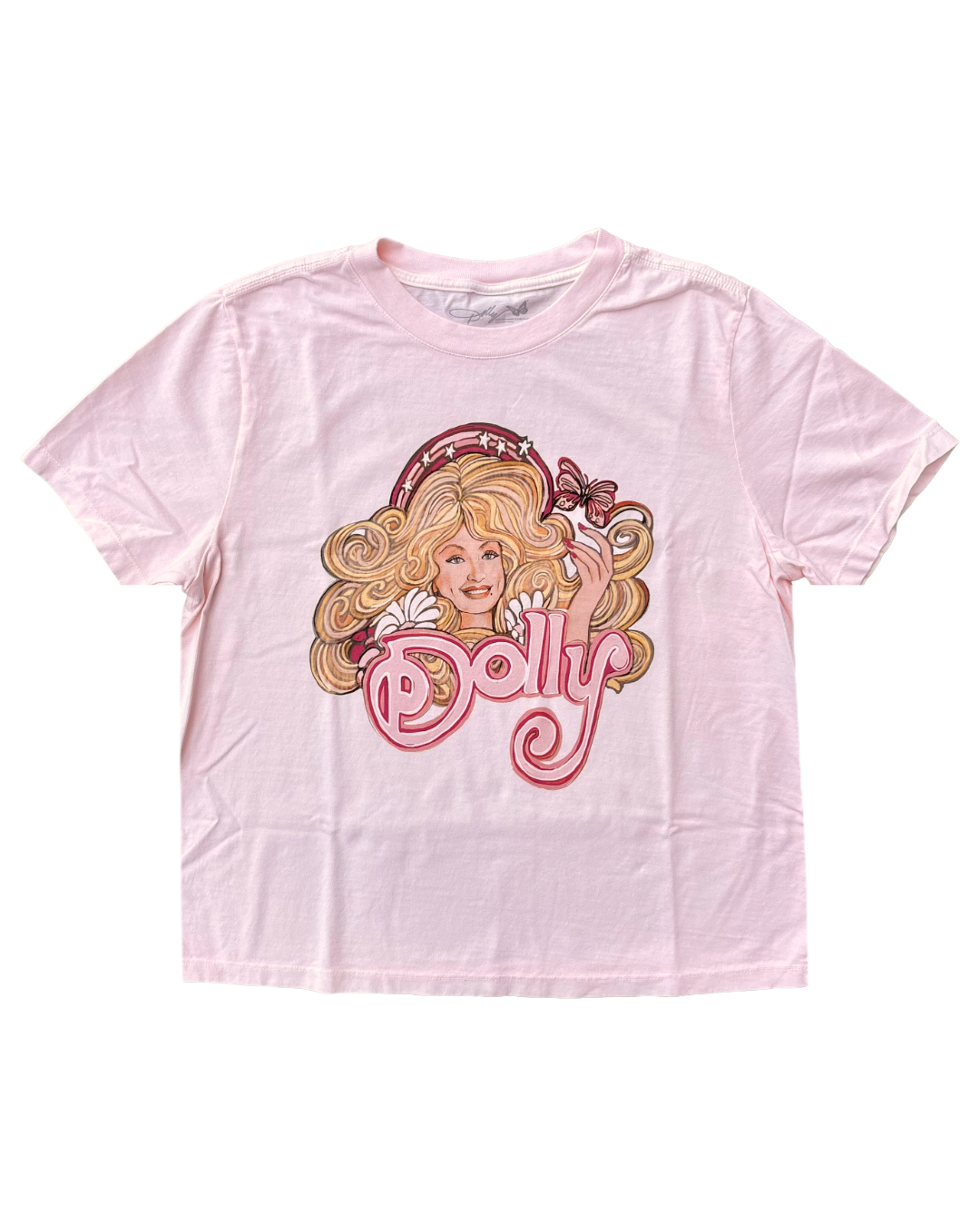 A light pink short-sleeve t-shirt featuring a vintage-style graphic of Dolly Parton with the word 'Dolly' in pink script across the front.