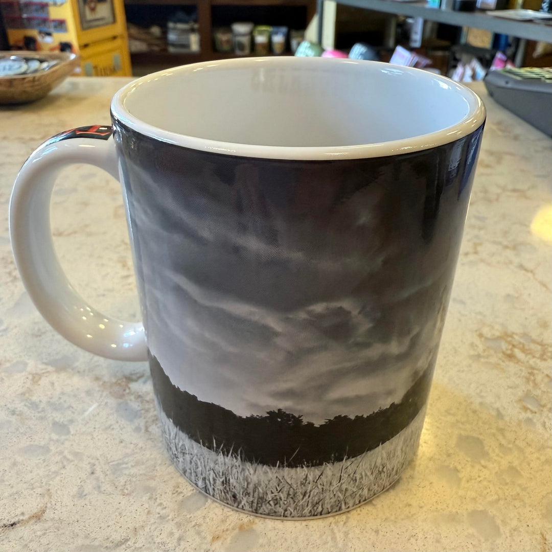 Close-up of "Tornado Alley" handle on Oklahoma mug with tornado and farm imagery