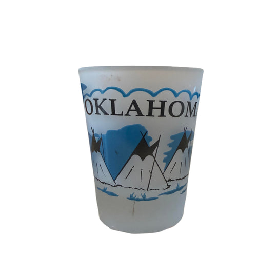 Frosted shot glass with black and blue Oklahoma design featuring teepees on one side and a buffalo on the other – unique souvenir gift