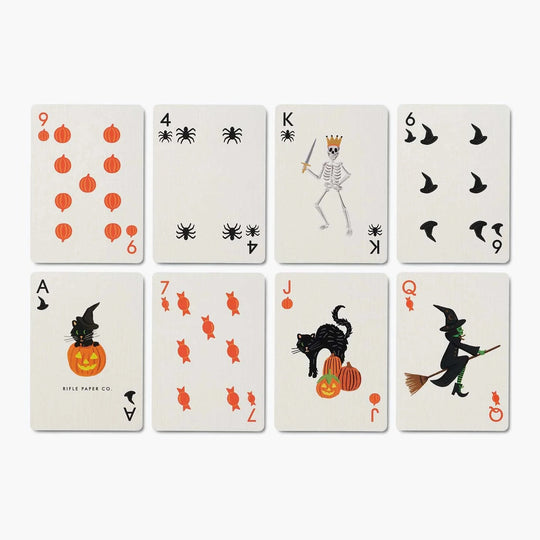 Eight Halloween-themed playing cards arranged in a 2x4 grid on a light gray background. The cards feature orange jack-o'-lanterns, black spiders, a skeleton with a crown, flying bats, candy canes, a black cat with a pumpkin, and a witch riding a broomstick.