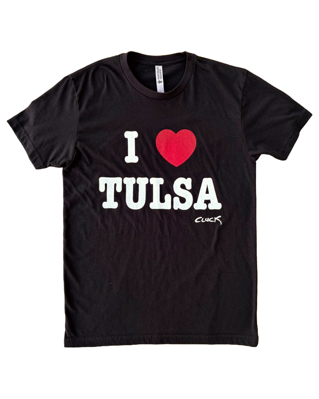 A black shirt with the text "I ❤️ TULSA" lays flat on a white background.