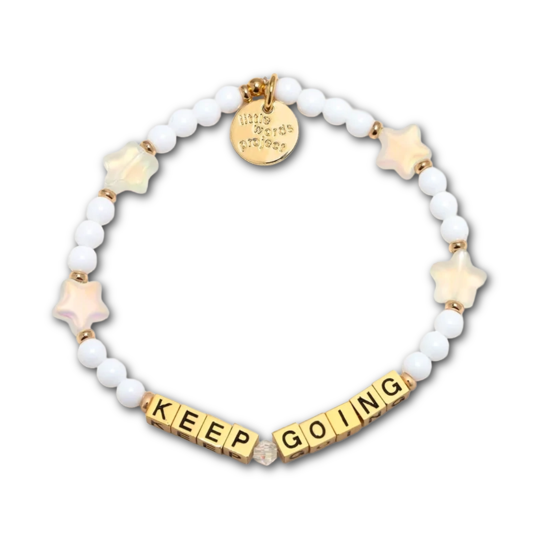 Bracelet with white and shimmery star-shaped beads, as well as gold letter beads spelling out "KEEP GOING".