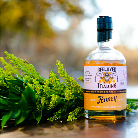 Bottle of local wildflower honey by Beeloved Trading, golden raw honey from Oklahoma