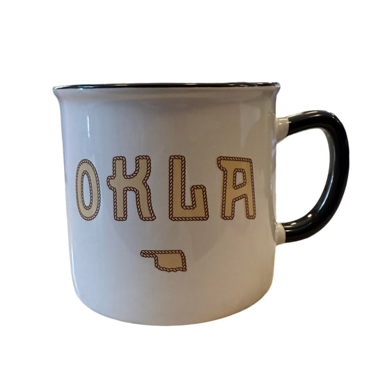 White ceramic mug with yellow OKLA text and rope border