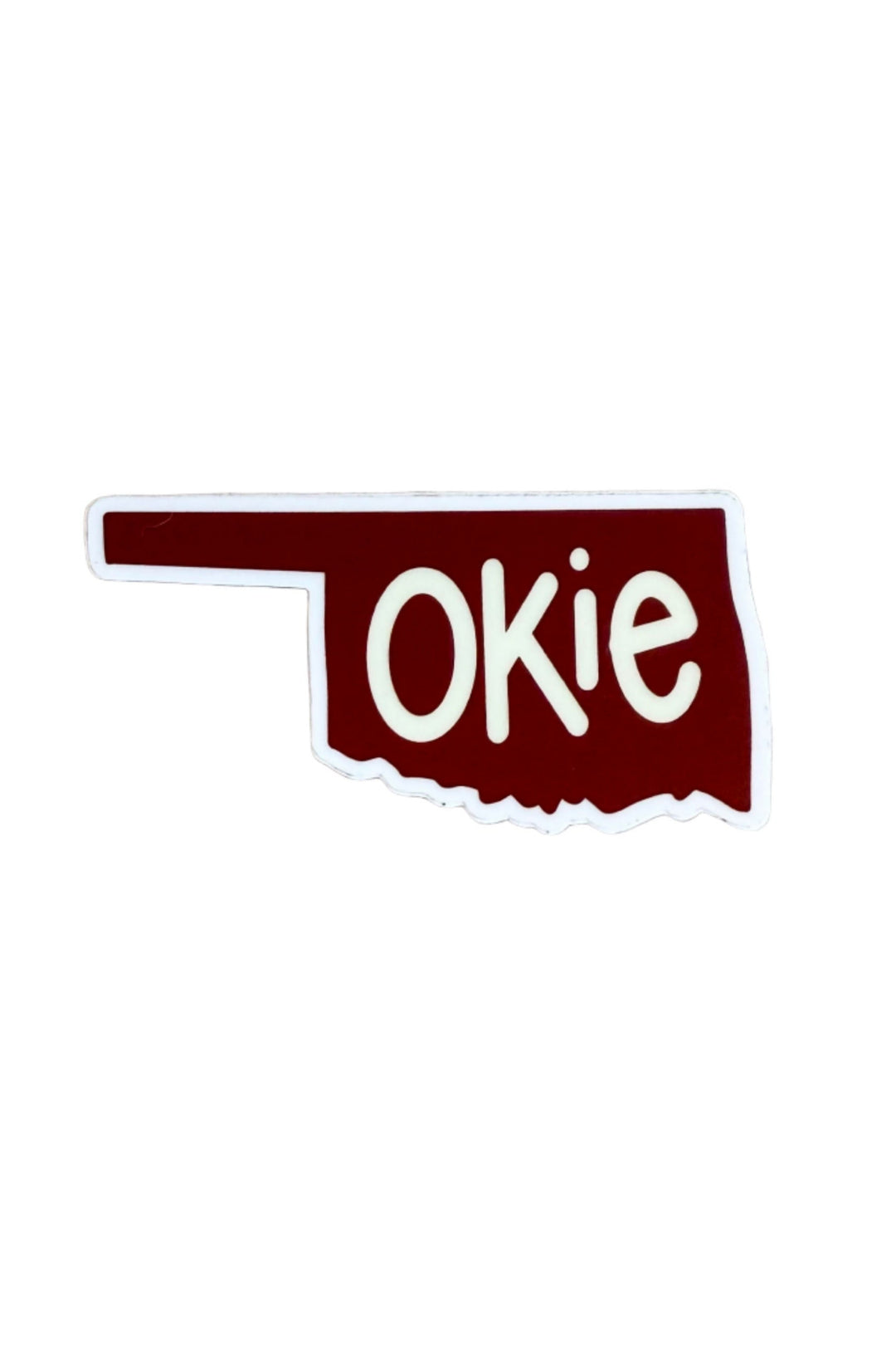 Sticker shaped like Oklahoma with crimson background and white “Okie” text – fun state pride souvenir
