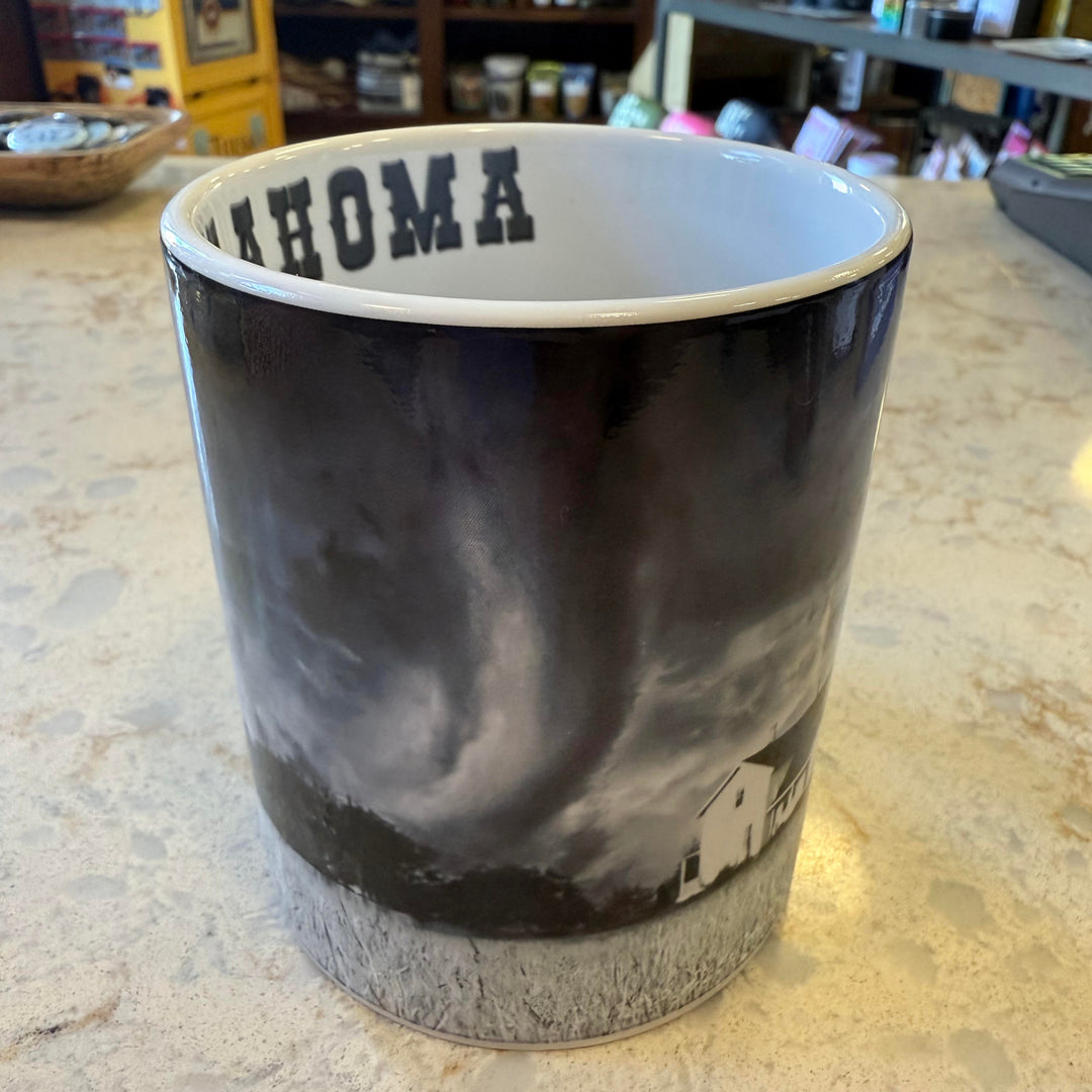 Tornado Alley themed Oklahoma mug with farmhouse illustration and stormy sky