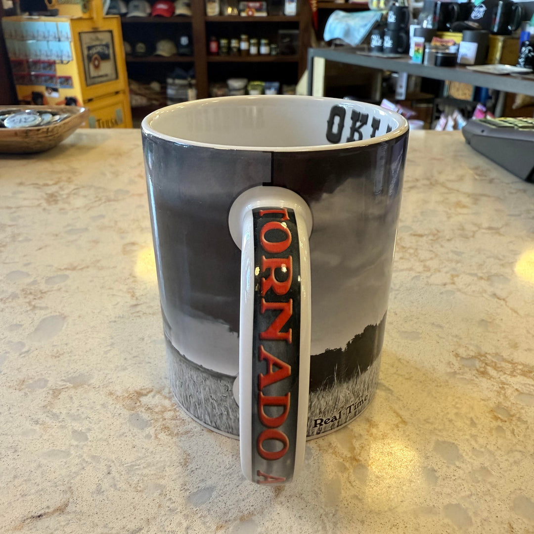Close-up of "Tornado Alley" handle on Oklahoma mug with tornado and farm imagery