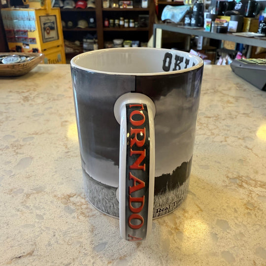 Close-up of "Tornado Alley" handle on Oklahoma mug with tornado and farm imagery