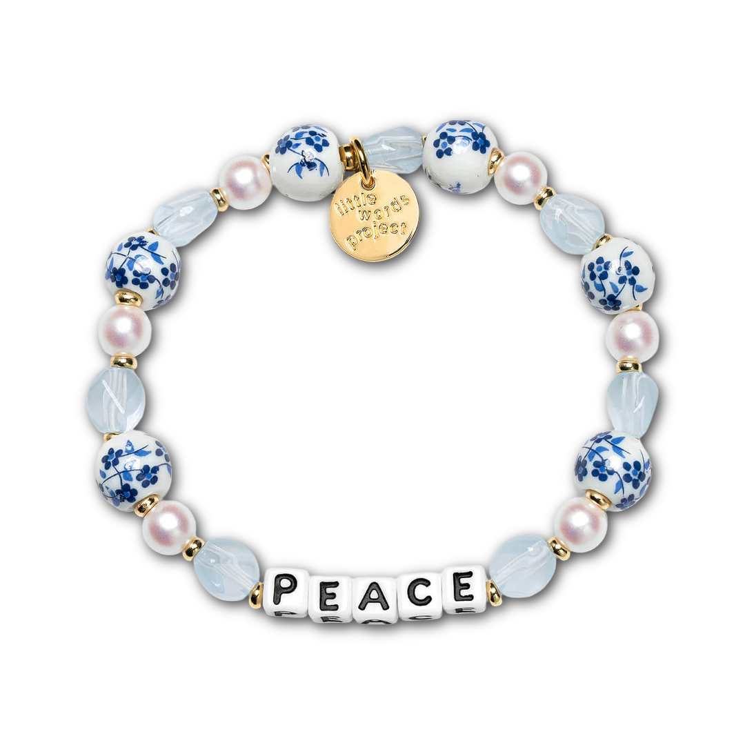 Bracelet with pearls, blue crystals, and porcelain-style beads beads, as well as letter beads spelling out "PEACE".