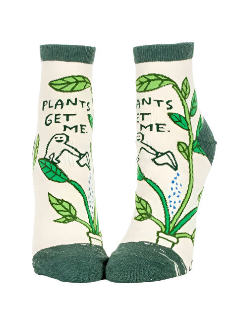 Women’s ankle socks with green plants and the phrase “Plants Get Me” printed on them
