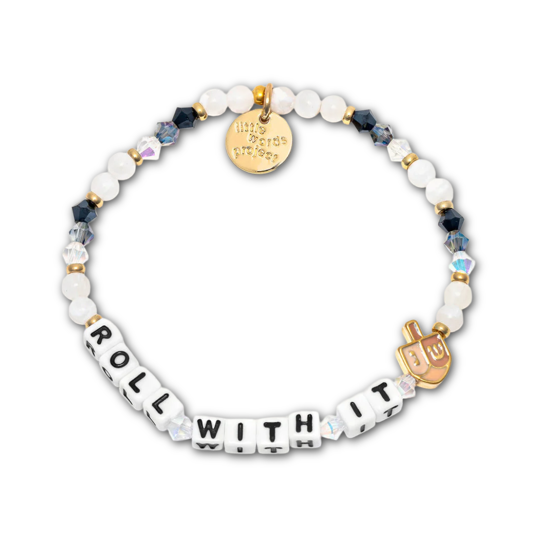 Bracelet with navy and white beads and letter beads spelling out "ROLL WITH IT", and a gold dreidel charm.