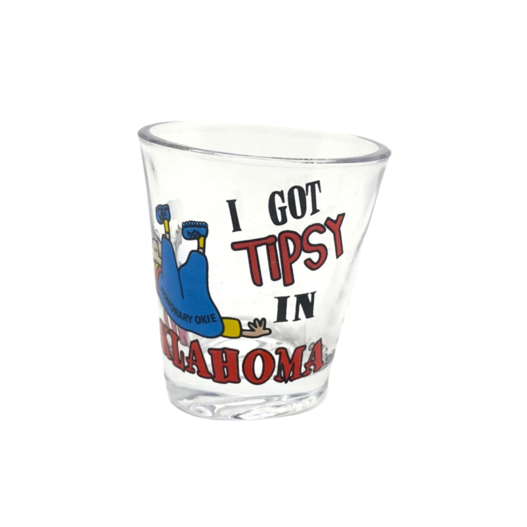 Humorous 'Tipsy in Oklahoma' shot glass with cartoon character illustration