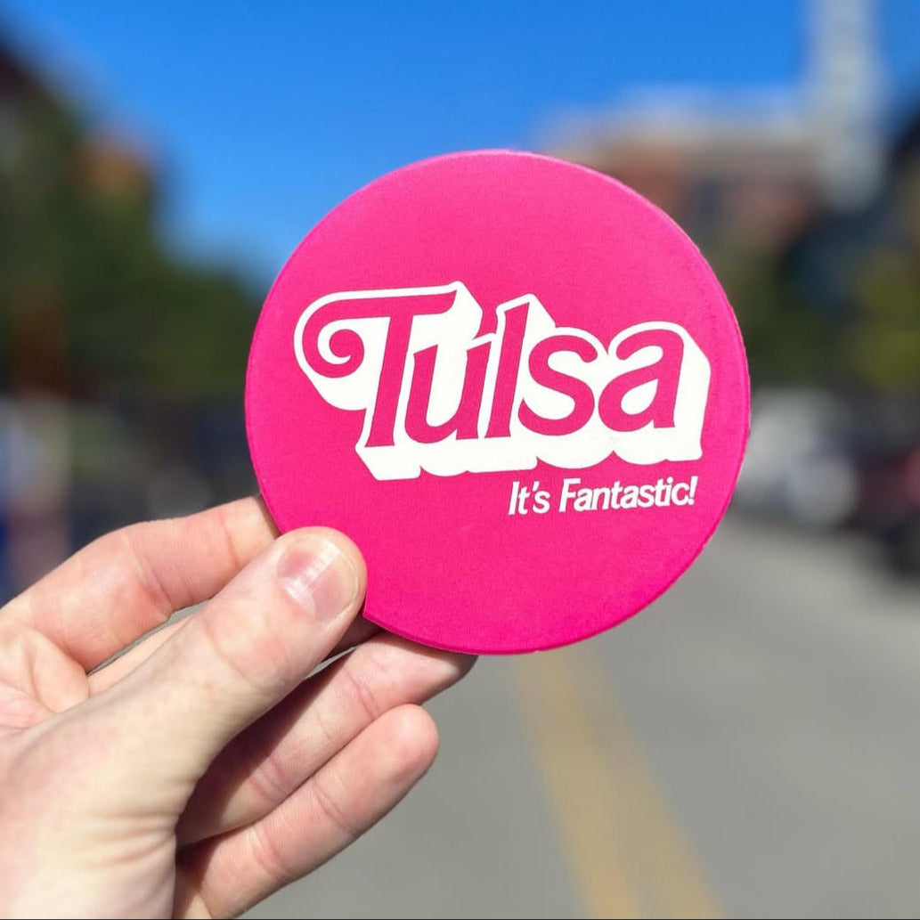 Tulsa souvenir coaster with Barbie-style text and vibrant pink pop culture aesthetic